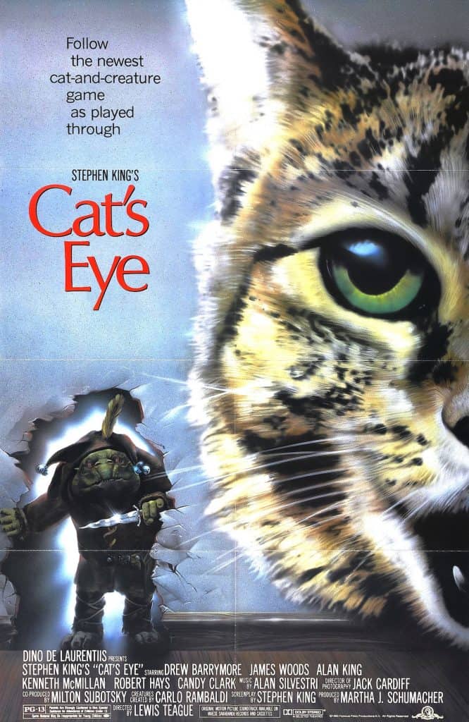 Movie poster for Stephen King's "Cat's Eye," featuring a large, intense cat's face on the right, a mysterious figure with a sword and shield on the left, and the film’s title and credits in the center and bottom.