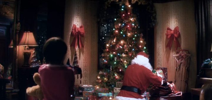 A child holding a teddy bear watches as a person dressed as Santa Claus places gifts under a decorated Christmas tree. The room is cozy, with warm lighting reminiscent of an Adult Swim special, and large red bows on the curtains, while a Yule log crackles gently in the fireplace.